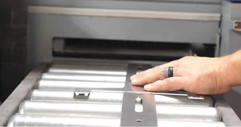 Fabricator deburring and finishing a sheet metal part